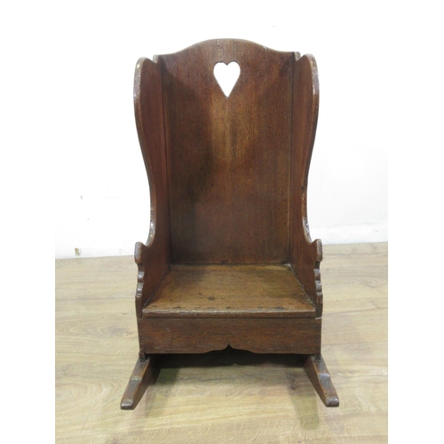 549 - An 18th Century oak wing backed child's Rocking Chair with pierced heart to back panel 2ft 1in H x 1... 