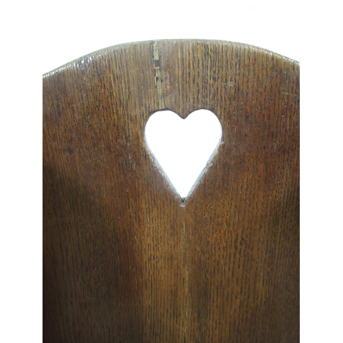 549 - An 18th Century oak wing backed child's Rocking Chair with pierced heart to back panel 2ft 1in H x 1... 