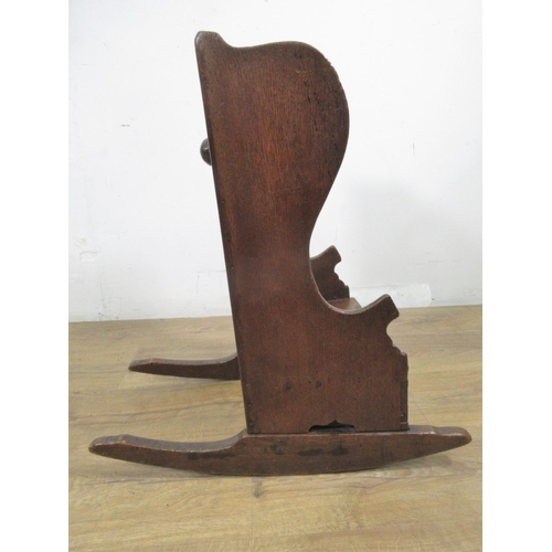 549 - An 18th Century oak wing backed child's Rocking Chair with pierced heart to back panel 2ft 1in H x 1... 