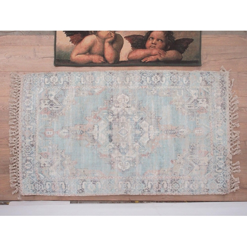 551 - A modern Wall Hanging depicting a cherub and a Rug