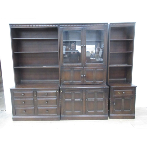 624 - An Ercol glazed Cabinet above two door cupboard base and two Bookcases