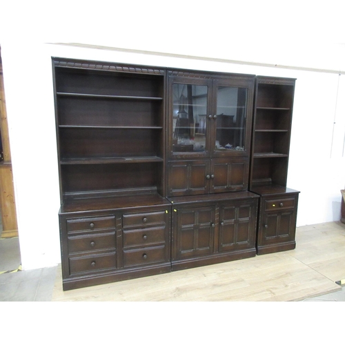 624 - An Ercol glazed Cabinet above two door cupboard base and two Bookcases