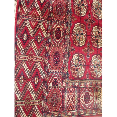 658 - A Tubris Super Rug on red ground with multiple borders with all over central lozenge designs 11ft 6i... 