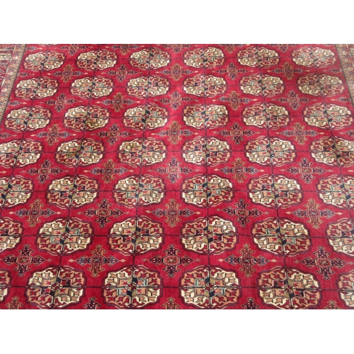 658 - A Tubris Super Rug on red ground with multiple borders with all over central lozenge designs 11ft 6i... 