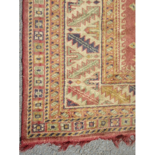 659 - A red and cream Rug with geometric multi borders 8ft 6in L x 6ft 4in W