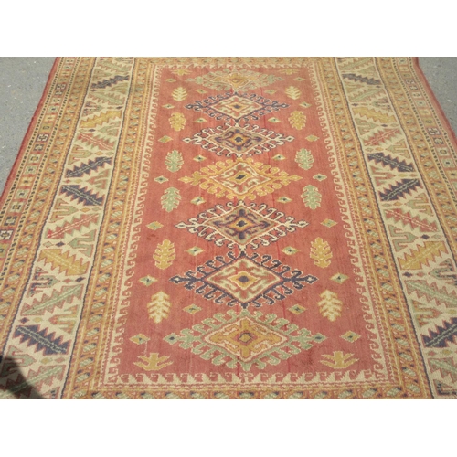 659 - A red and cream Rug with geometric multi borders 8ft 6in L x 6ft 4in W