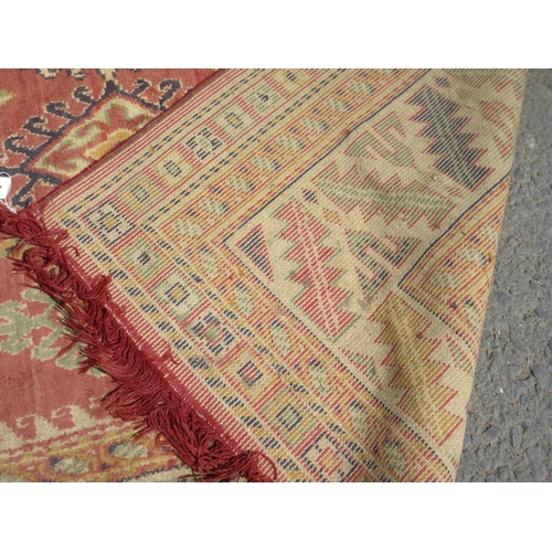 659 - A red and cream Rug with geometric multi borders 8ft 6in L x 6ft 4in W