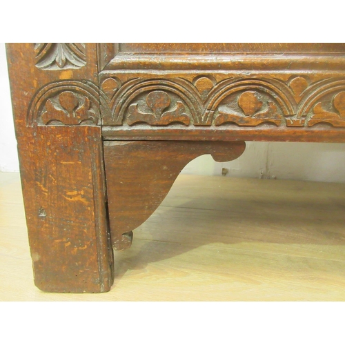 89 - A 17th Century oak Coffer with moulded plank top above lunette carved frieze and three marquetry inl... 