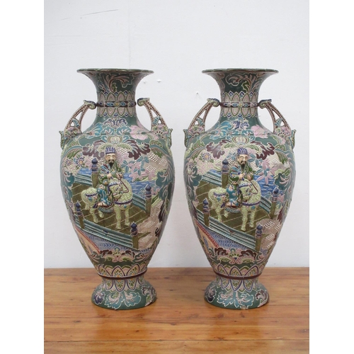 99 - A pair of 20th Century Japanese Vases with relief moulded decoration of figure on horseback amongst ... 