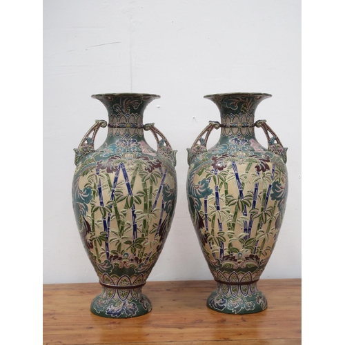 99 - A pair of 20th Century Japanese Vases with relief moulded decoration of figure on horseback amongst ... 