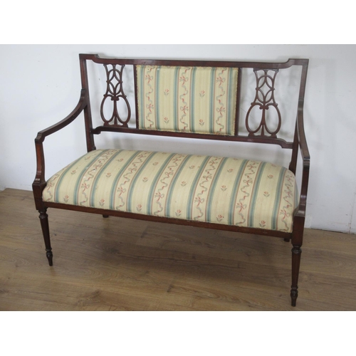 653 - A Victorian mahogany salon Settee in cream ribbon and striped upholstery