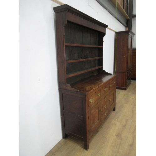 642 - An 18th Century oak Dresser and rack the base fitted three frieze drawers above a pair of cupboard d... 