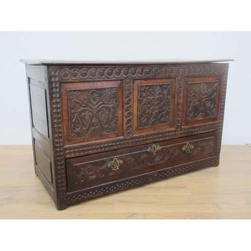 647 - A 17th Century oak Coffer with moulded plank lid above three foliate carved panels and lower drawer ... 