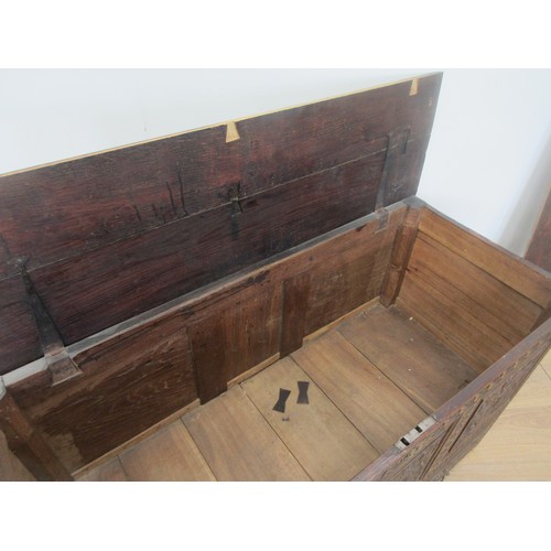 647 - A 17th Century oak Coffer with moulded plank lid above three foliate carved panels and lower drawer ... 