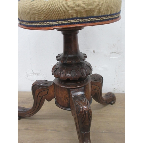 518 - A Victorian carved oak revolving Piano stool with needlework top 1ft 6in H