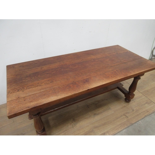 523A - An oak Refectory Table in the 17th Century style on baluster turned columns and central stretcher 6f... 