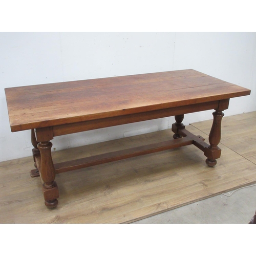 523A - An oak Refectory Table in the 17th Century style on baluster turned columns and central stretcher 6f... 