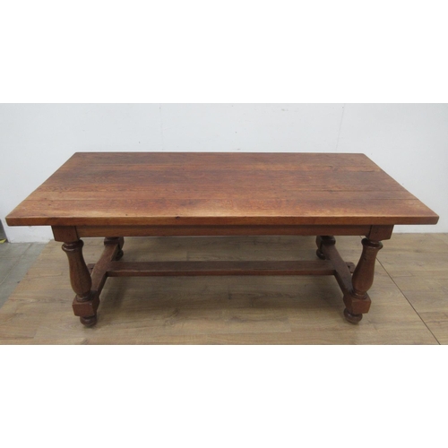 523A - An oak Refectory Table in the 17th Century style on baluster turned columns and central stretcher 6f... 