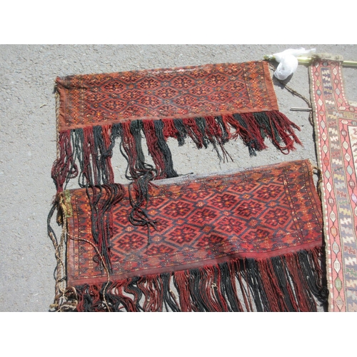 524 - A North African Wall Hanging decorated with stylised animals and two other red ground Wall Hangings