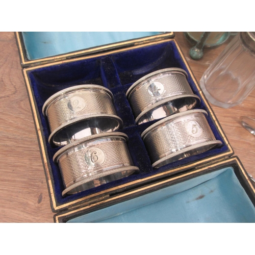 562 - A box of brassware including Jam Pan, three Candlesticks, Vase, plated Condiment Stand with glass co... 