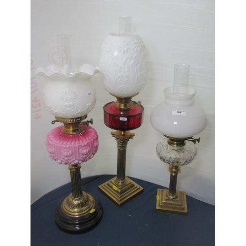 588 - Three brass Oil Lamps with glass reservoirs and shades