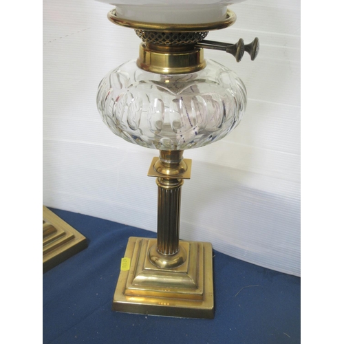 588 - Three brass Oil Lamps with glass reservoirs and shades