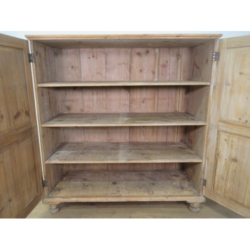 636 - An antique pine Cupboard fitted pair of panelled doors on turned supports 5ft 1in H x 4ft 7in W