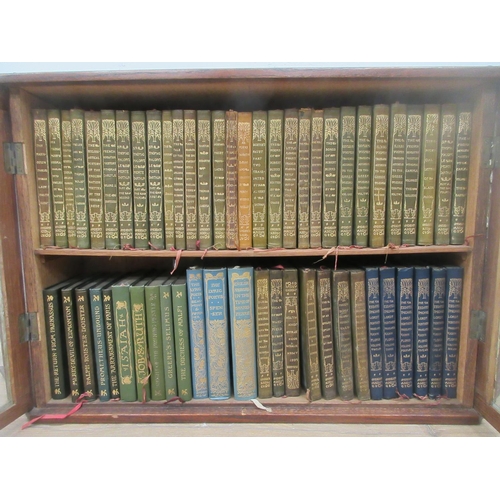 639 - An oak and glazed two door hanging Bookcase containing a quantity of the Classics