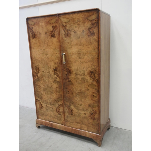 646 - A walnut two door Wardrobe enclosing hanging space (one handle missing) 3ft 10 W 6ft 2H