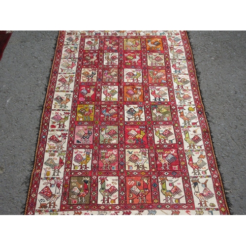 652 - A cream ground Rug with geometric border and stylised cockerel designs 6ft 10in x 4ft 2in