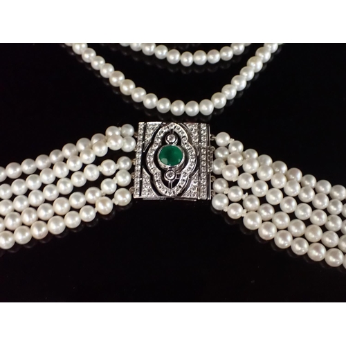 130 - A five row Cultured Pearl Necklace on rectangular emerald and diamond clasp rubover-set round emeral... 