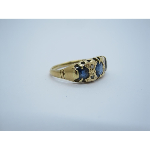 139 - A Sapphire and Diamond Ring pavé-set three cushion-cut graduated sapphires with diamond points betwe... 