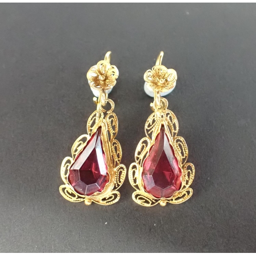 147 - A pair of filigree Ear Pendants each set pear-cut red stone on wire fittings