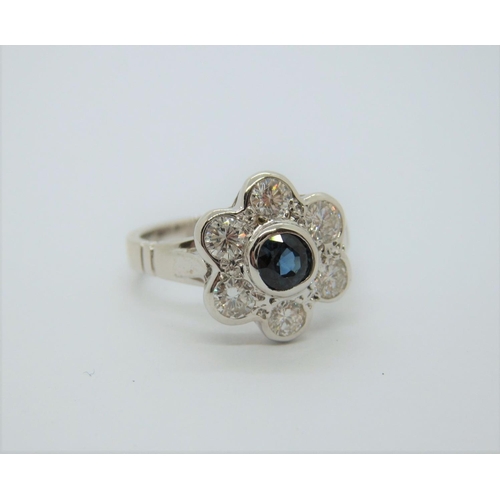 152 - A Sapphire and Diamond Daisy Cluster Ring rubover-set round sapphire within frame of six brilliant-c... 