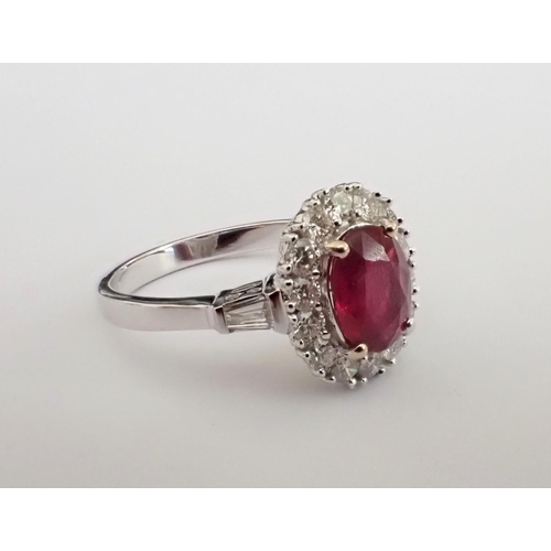 154 - A Ruby and Diamond Cluster Ring claw-set oval-cut enhanced ruby, 1.52cts, within frame of brilliant-... 