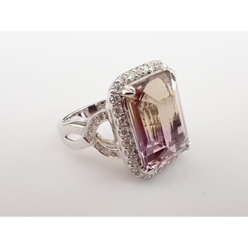 164 - An Ametrine and Diamond Ring corner claw-set step-cut ametrine within a frame of pavé-set brilliant-... 