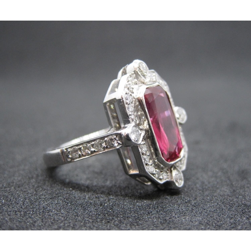 166 - An Art Deco style Ruby and Diamond Cluster Ring rubover-set scissor-cut stone, 2.36cts, within frame... 