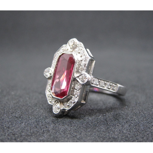 166 - An Art Deco style Ruby and Diamond Cluster Ring rubover-set scissor-cut stone, 2.36cts, within frame... 