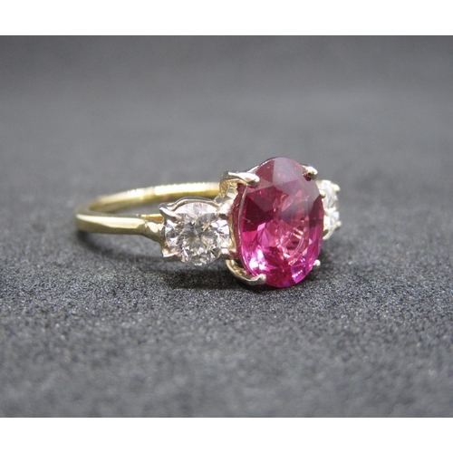 168 - A Pink Sapphire and Diamond three stone Ring claw-set oval-cut sapphire, 3.09cts between two brillia... 