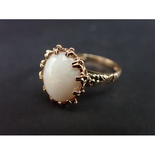 181 - An Opal Ring claw-set single oval cabochon in 9ct gold, ring size M