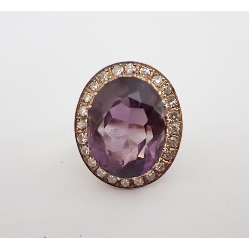 183 - An Amethyst and Diamond Ring claw-set oval-cut amethyst within frame of pavé-set eight-cut diamonds,... 