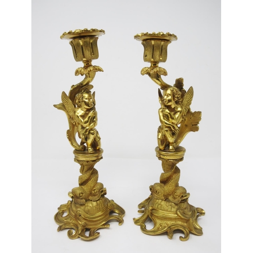 208 - A pair of ormolu Candlestick with figural columns of boy and girl winged cherubs on dolphin supports... 