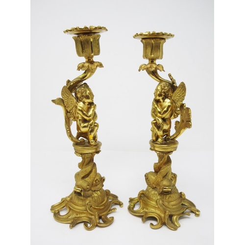 208 - A pair of ormolu Candlestick with figural columns of boy and girl winged cherubs on dolphin supports... 