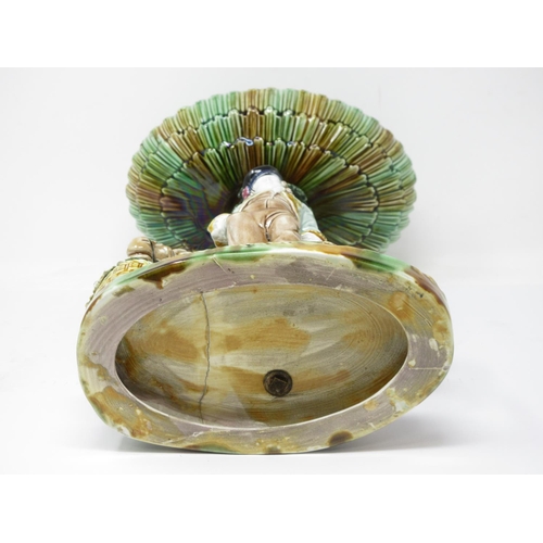 255 - An English majolica Comport with oval dish top, fluted edge on tree trunk support with standing figu... 