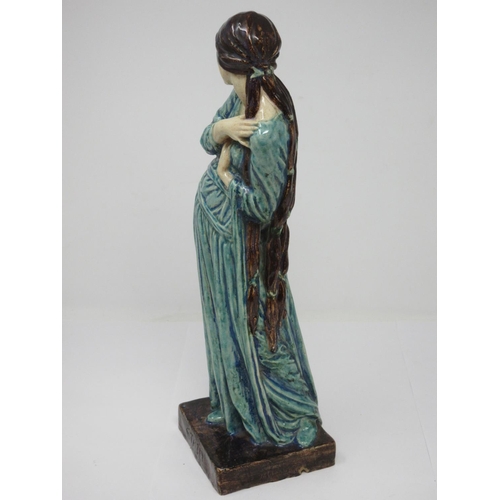 260 - An Art Nouveau style pottery Figure of standing female figure with long brown hair, turquoise glazed... 