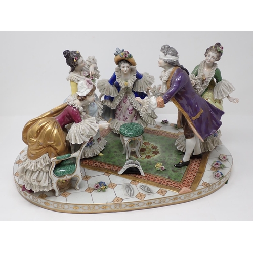 263 - A Dresden Centrepiece of five figures playing blind man's bluff, with oval base, 17in W