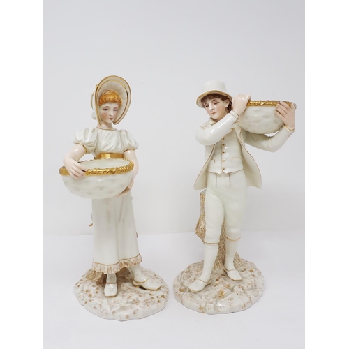 293 - A pair of Worcester Hadley standing figures of young lady and gentleman holding baskets with gilt de... 