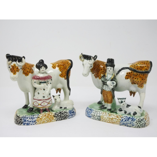 294 - A pair of early 19th Century pottery Cow and Calf with cowman and milk maid Figures on oblong bases,... 