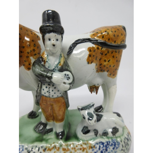 294 - A pair of early 19th Century pottery Cow and Calf with cowman and milk maid Figures on oblong bases,... 