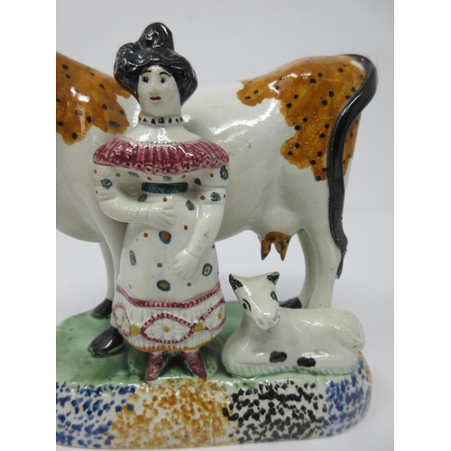 294 - A pair of early 19th Century pottery Cow and Calf with cowman and milk maid Figures on oblong bases,... 